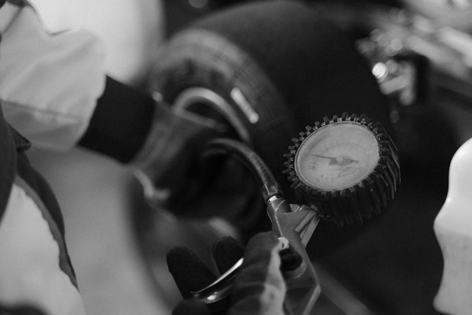 Mechanic checking tire air pressure